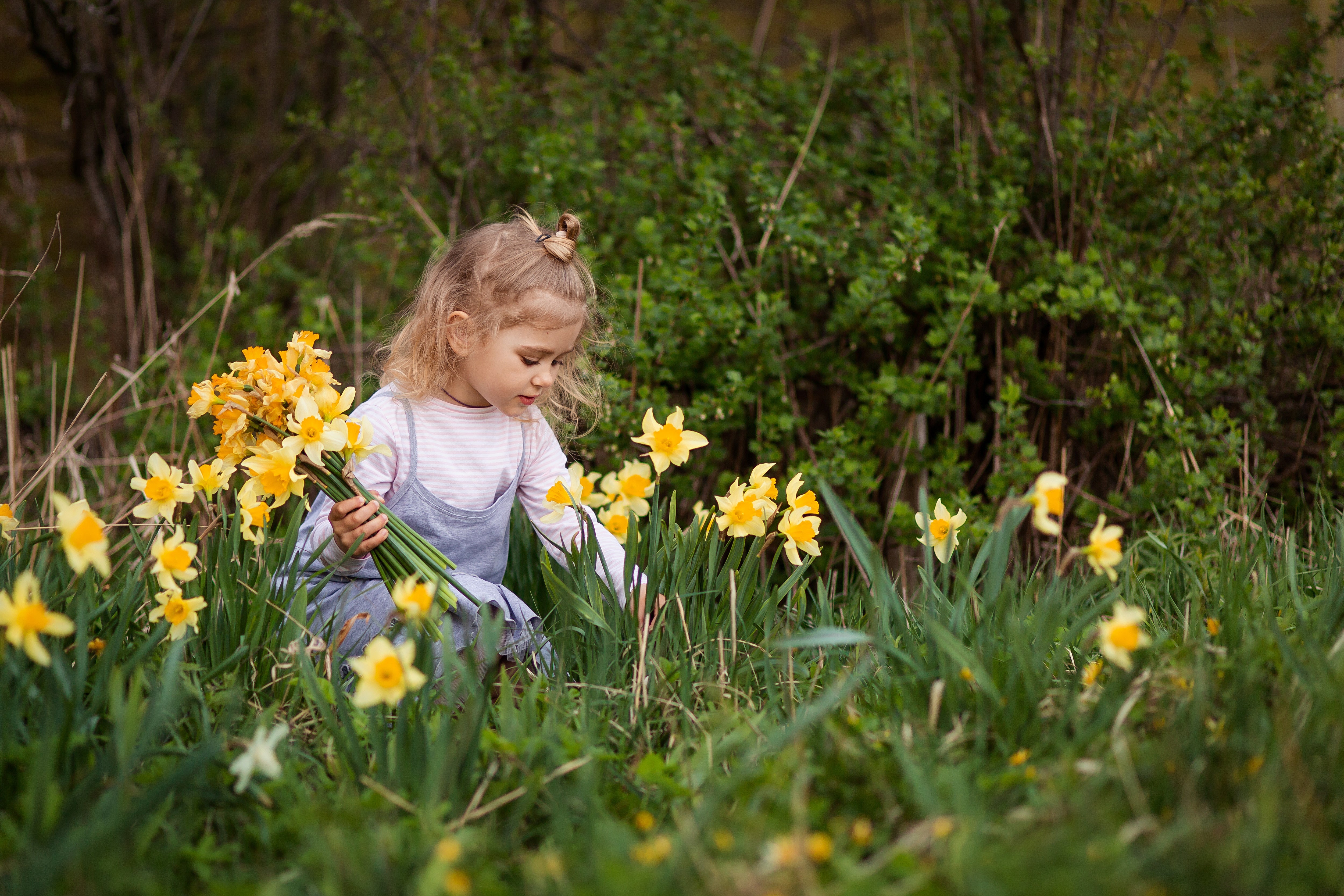 Toddler girl with spring flowers